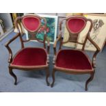 A pair of Edwardian mahogany salon armchairs having lattice pierced back and on cabriole legs