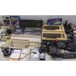 A selection of vintage gaming systems and accessories to include a Commodore A1200, Sega Mega