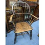 A 19th century elm seated and ash spindle back Windsor armchair on turned shaped legs Location: