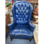 A mid 20th century Queen Anne style blue leather button back upholstered wing back armchair together