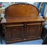 A Victorian mahogany chiffonier having a raised back above two drawers and two panelled doors, 137cm