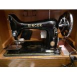 A Singer 99K electric sewing machine on an oak plinth in a faux reptile travel case and rubber