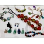 A quantity of stone pendants, a painted glass bead necklace, an amber effect and green bead