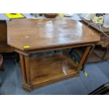 A mid/late 20th century walnut octagonal two tier table supported by turned columns and with applied