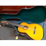 A German Oscar Teller classic guitar having 6 strings (5 intact) and a fitted hard case