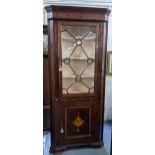 A George III mahogany corner cabinet with dentil moulded cornice, single glazed door flanked by