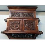 A late 19th/early 20th century mahogany wall hanging cabinet having a dental moulded cornice above