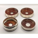 Two silver coasters and a pair of wine bottle coasters