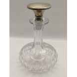 A sterling silver topped squat formed decanter, to stopper engraved with initials and a floral