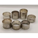 Seven mixed early 20th century silver napkin rings, some engraved with initials 210.7g Location:
