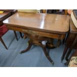 A Regency inspired mahogany fold over tea table having applied brass mounts and inlaid quadrafoil