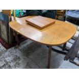 A G-Plan teak extending dining table with butterfly opening extra leaf, on shaped plain legs 73cm