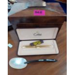 A sarcophagus tea caddy A/F, a Colibri gold tone pen and a mother of pearl spoon. Location:RAF