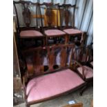An early 20th century mahogany Chippendale style two seater chair together with six matching