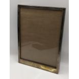 A sterling silver rectangular shaped photograph frame with initials, 21.5cm x 16cm Location: