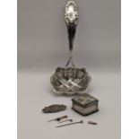 A mixed lot to include silver sugar spreader, together with a silver pill box hallmarked