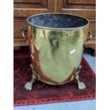 A 19th Century brass riveted coal bucket on lion paw feet, 30cm H x 34cmW