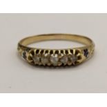 A yellow metal five stone diamond ring having a floral engraved shank, 1.7g Location: