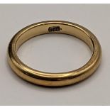 A yellow metal wedding band, stamped 18ct gold, total weight 3.6g Location: