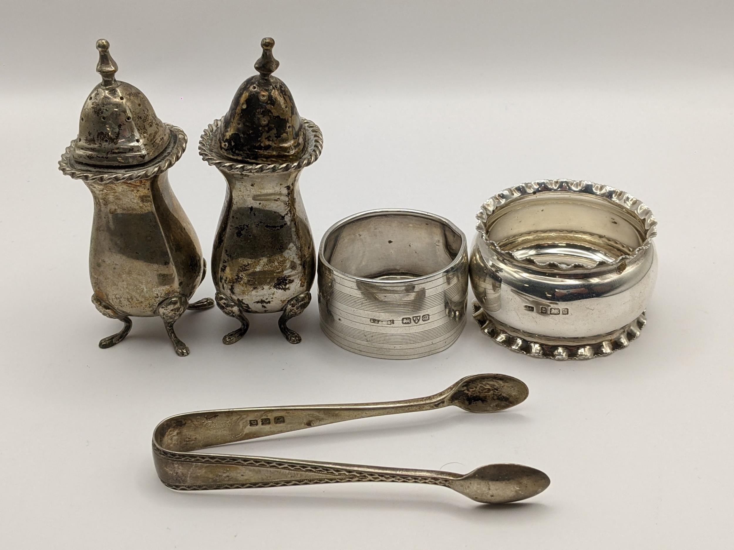 Mixed silver to include napkin rings, salts and sugar tongs, 149.7g Location: