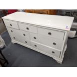 A modern Frank Hudson sideboard having 7 drawers on bracket shaped feet, 79cmHigh x 148cmWide.