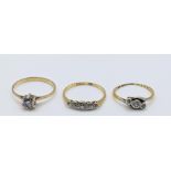 Two 18ct gold rings set with diamonds, 3.3g, together with a yellow metal ring, 1.7g Location: