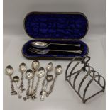 A cased silver spoon and fork hallmarked Birmingham 1900, together with a silver toast rack, along