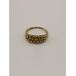 An 18ct gold ring having a beaded design, total weight 3.5g Location: