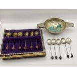 Two sets of early 20th century silver hallmarked coffee bean spoons, 51.9g, together with a white