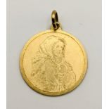 A 18ct gold pendant with engraved detail of a mother with child, total weight 6.4g Location: