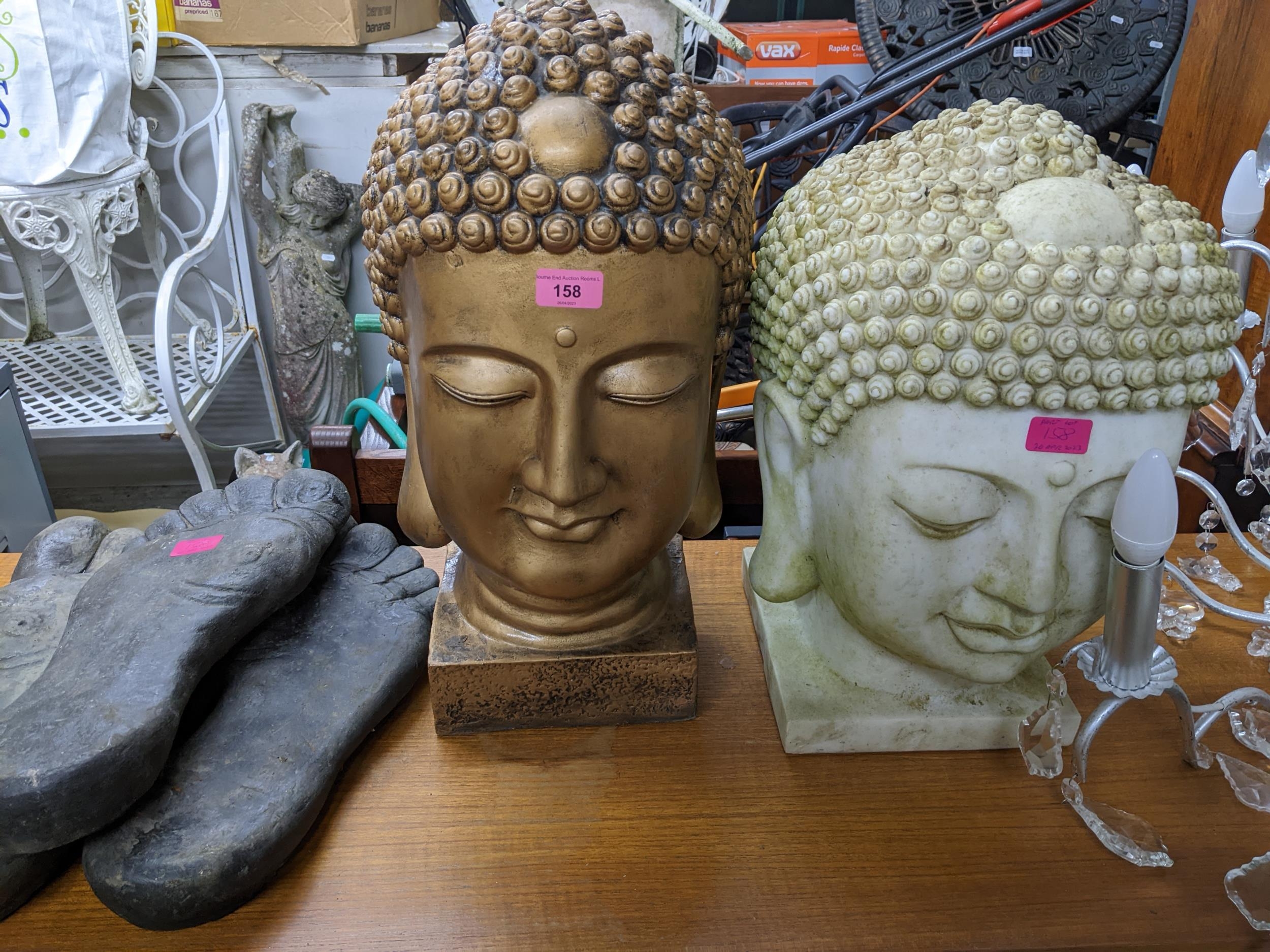 A composition moulded Thai Buddha head and a gilt example, along with three feet shaped stepping