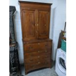 A Georgian mahogany secretaire cabinet, the top with stepped cornice, twin fielded doors and three