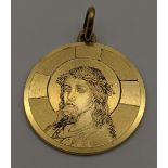A 18ct gold pendant with engraved detail of Jesus Christ, total weight 6.4g Location: