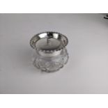 An Edwardian cut glass and silver powder jar, the rim with a crimped edge and the lid engraved