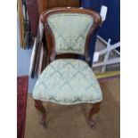 A late 19th/early 20th century French oak side chair having carved c scrolls and on front cabriole