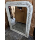 A cream painted carved wooden wall mirror with rectangular plate mirrored glass 104cm x 77cm