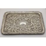 An early 20th century silver embossed rectangular shaped tray decorated with flowers and C-
