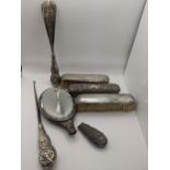 Silver dressing table items A/F to include three silver brushes, a mirror, silver handle shoe horn