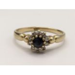 An 18ct gold sapphire and diamond cluster ring, 2.2g Location: