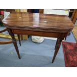 A Regency mahogany fold over tea table having string inlay on turned legs, 74.5cmH x 85.5cmW