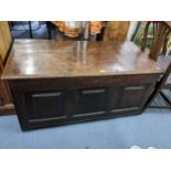 An early 18th century oak panelled coffer having a hinged top and on later castors, 59cm h x 121cm w