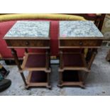 A pair of French mahogany bedside cabinets, three tiers supported on turned columns, inset