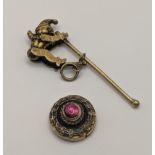 A Victorian yellow metal garnet locket together with a gold plated Punchinello articulated Jester