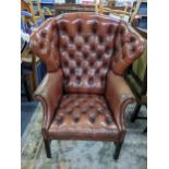 A reproduction leather 'Chesterfield' button wing bang armchair Location: