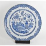 A large Chinese Qing dynasty blue and white porcelain charger, in the Kangxi style with central