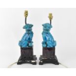 A pair of Chinese turquoise glazed dogs of Foo lamps, the temple guardians facing each other, on a