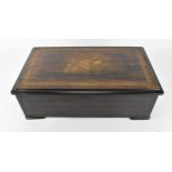 A late 19th/early 20th century Swiss rosewood and inlaid lever wind music box, the top with