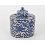 An Ottoman ceramic ink well and pen holder, of cylindrical form with Iznik blue and white foliage