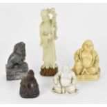 A group of Oriental laughing Buddhas, comprising a dehua model, a carved wooden model and a resin