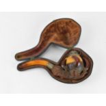 A large Meerschaum pipe carved in the form of a bird’s claw, with silver mounted amber cover and